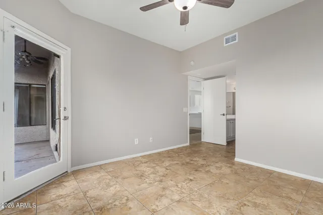 wooden floor in an empty room and a bathroom