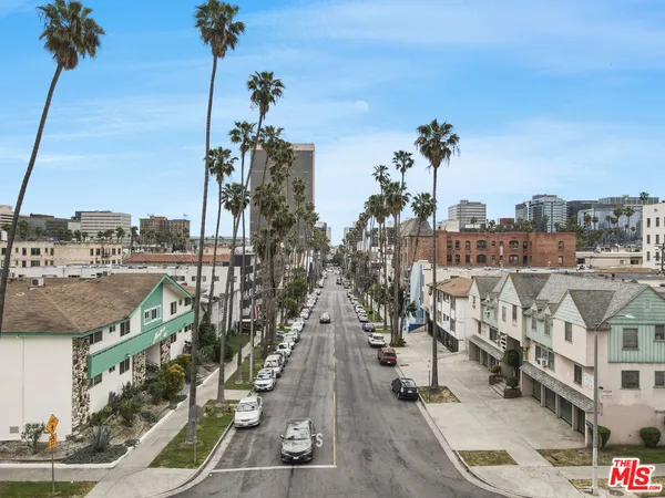 a city street with tall building next to a road