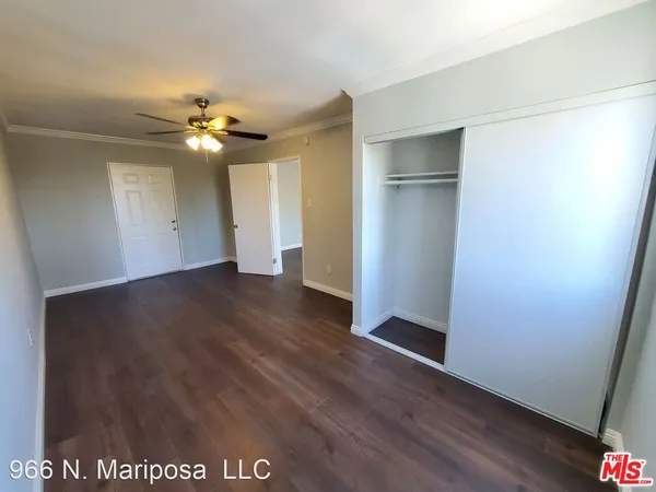 a kitchen with a sink a refrigerator and cabinets
