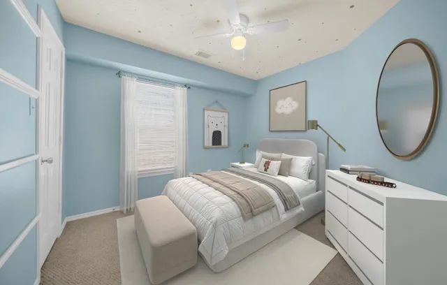 a bedroom with bed and a mirror