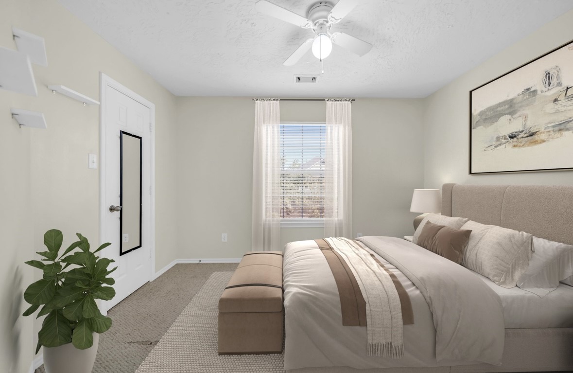 8918 Elm Drake Lane Humble, TX 77338 - Photo 13 of 20 a bedroom with a bed and a potted plant