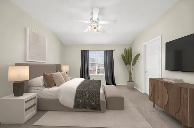 a spacious bedroom with a large bed and a flat screen tv