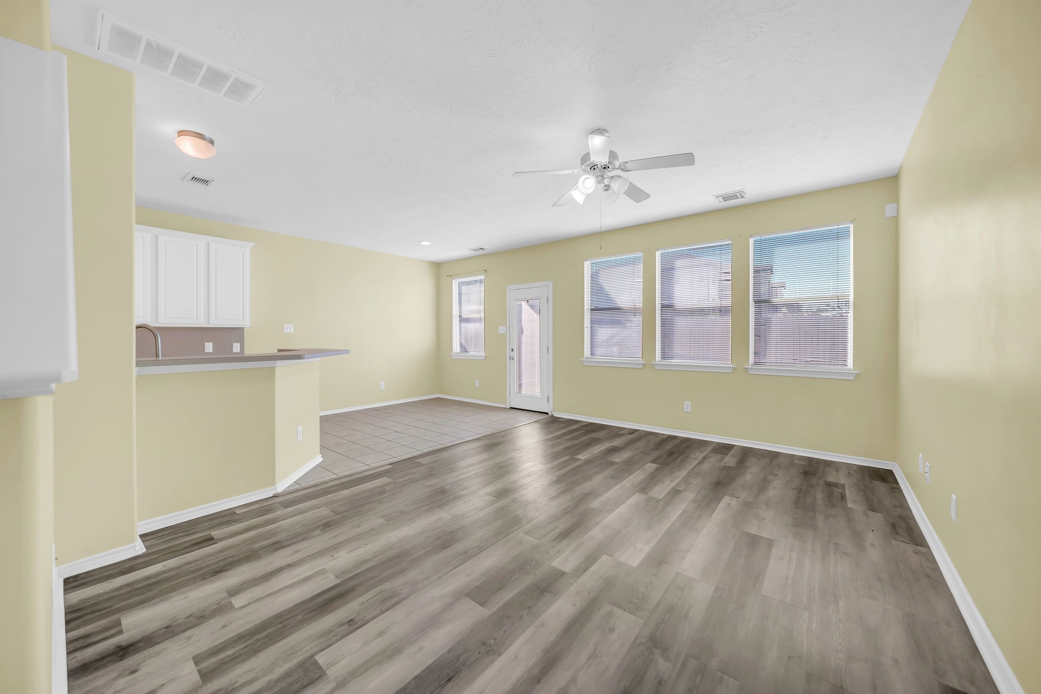 8918 Elm Drake Lane Humble, TX 77338 - Photo 2 of 20 a view of an empty room with a window and wooden floor