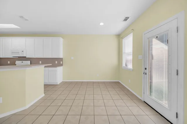 a view of a kitchen with white cabinets