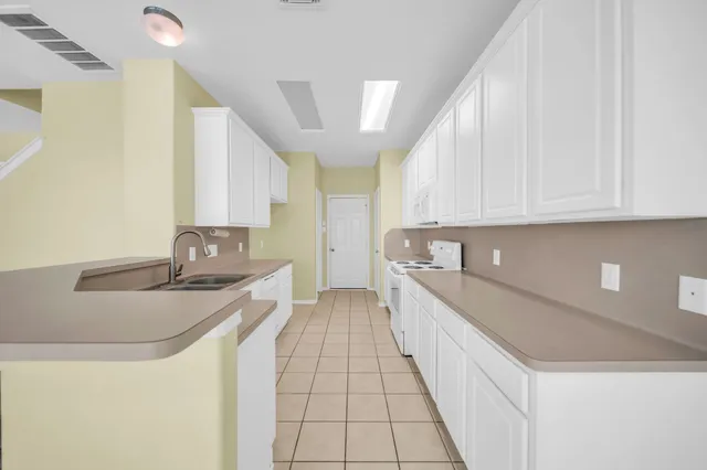 a kitchen with a sink and cabinets