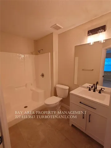a kitchen with a refrigerator and a sink
