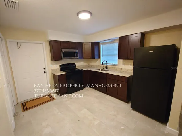 a view of a field with trees in the background