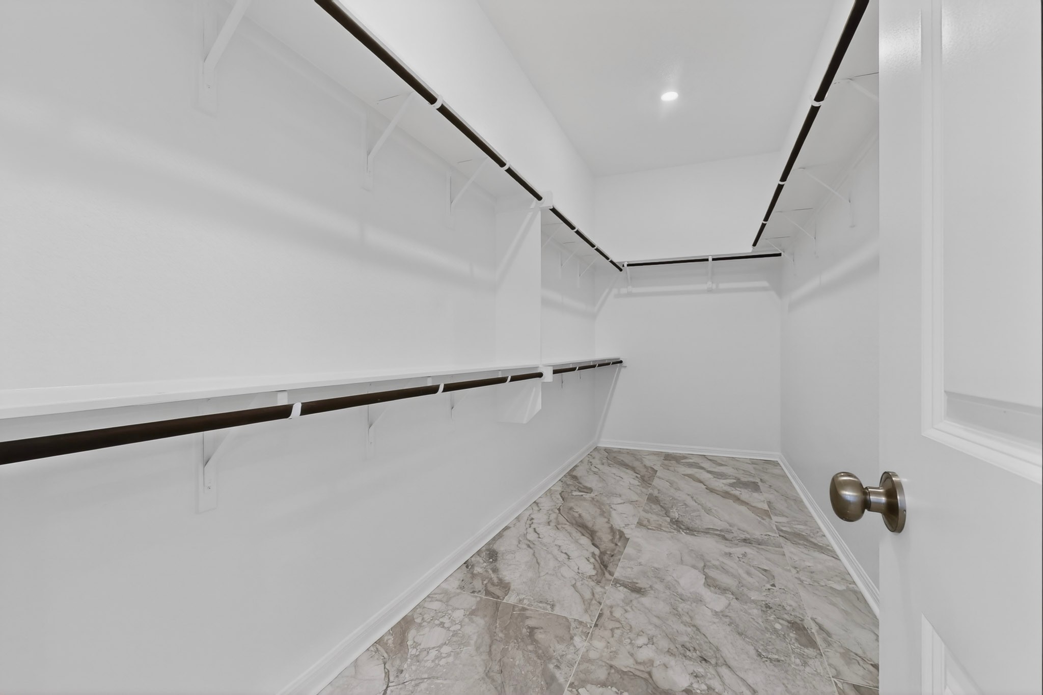 2308 Mondello Path Leander, TX 78641 - Photo 16 of 39 Ample shelving and hanging space defines this generously proportioned walk-in closet.