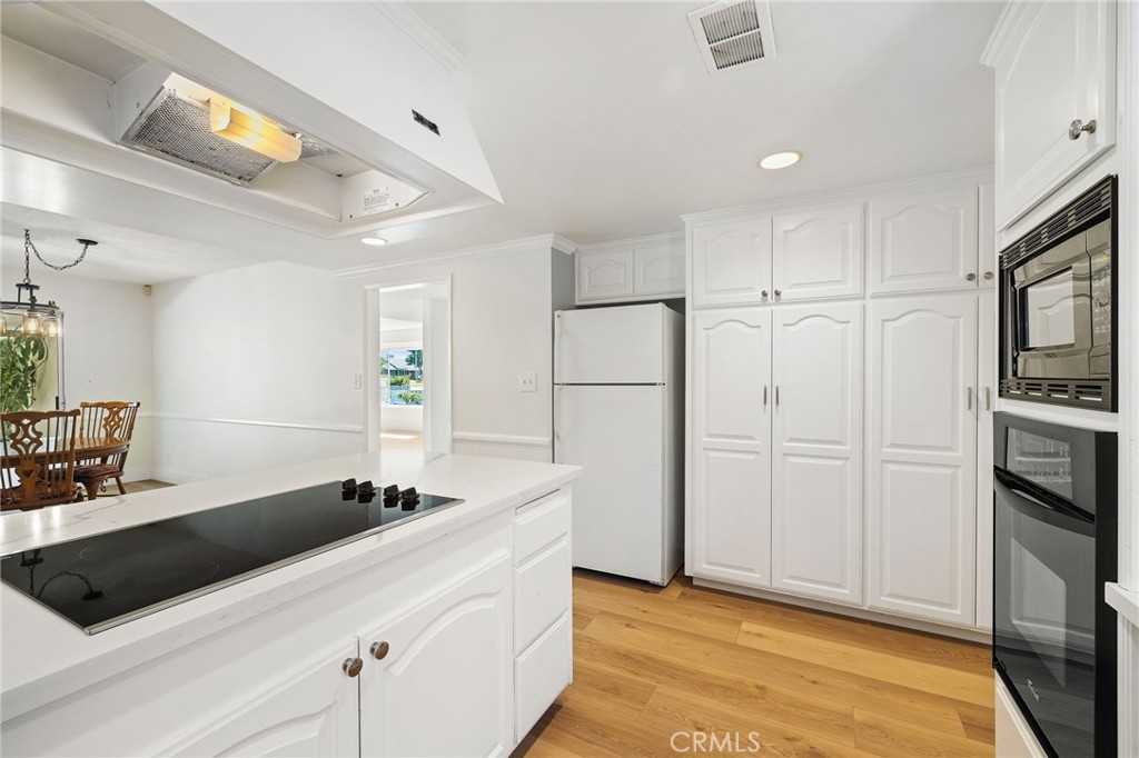 1176 Steele Drive Brea, CA 92821 - Photo 11 of 39 a kitchen with a refrigerator and a sink