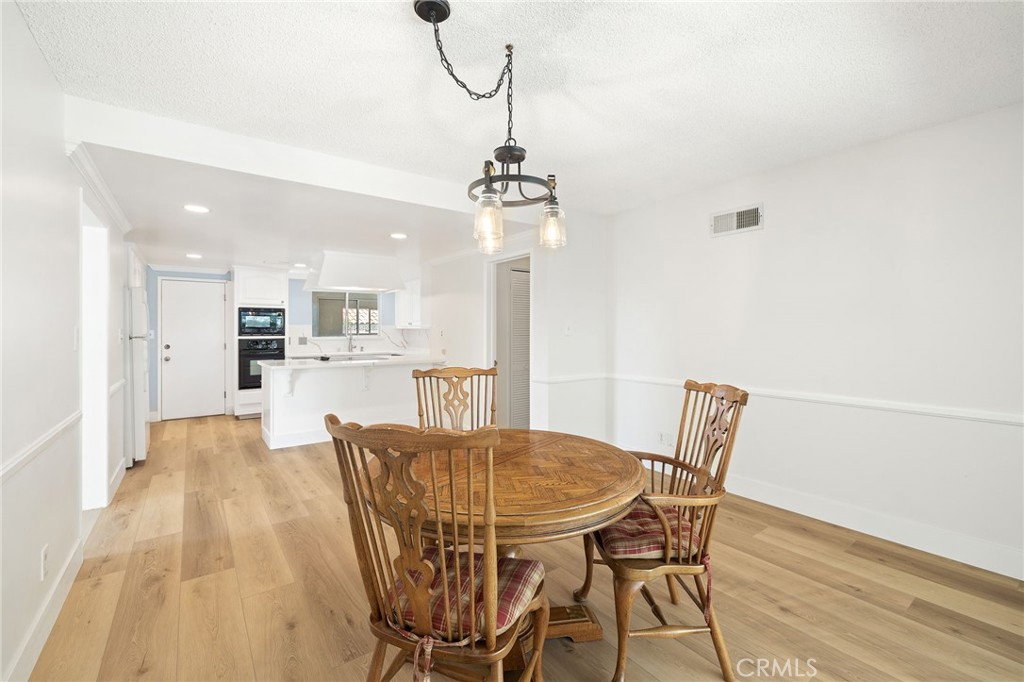 1176 Steele Drive Brea, CA 92821 - Photo 12 of 39 a view of a dining room with furniture and wooden floor