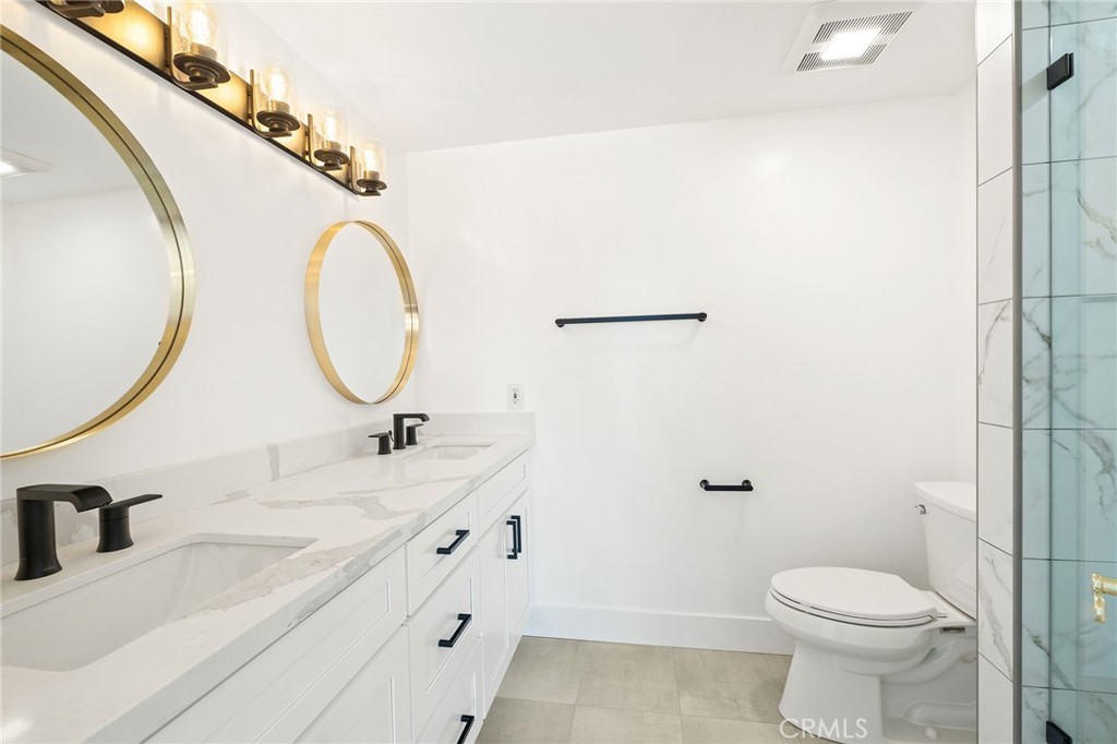 1176 Steele Drive Brea, CA 92821 - Photo 18 of 39 a bathroom with a granite countertop sink mirror vanity and toilet