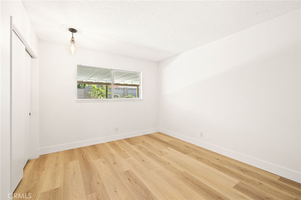 1176 Steele Drive Brea, CA 92821 - Photo 21 of 39 a view of empty room with wooden floor and fan