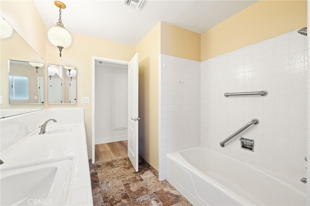 1176 Steele Drive Brea, CA 92821 - Photo 22 of 39 a bathroom with a tub a sink and a mirror