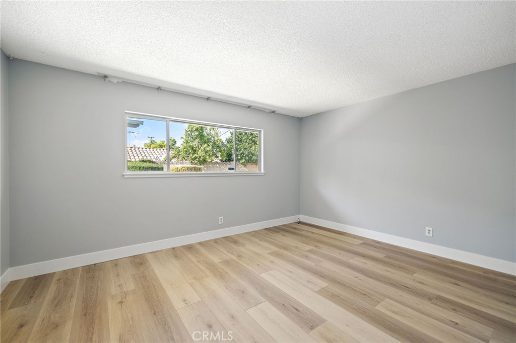 1176 Steele Drive Brea, CA 92821 - Photo 24 of 39 a view of an empty room with wooden floor and a window