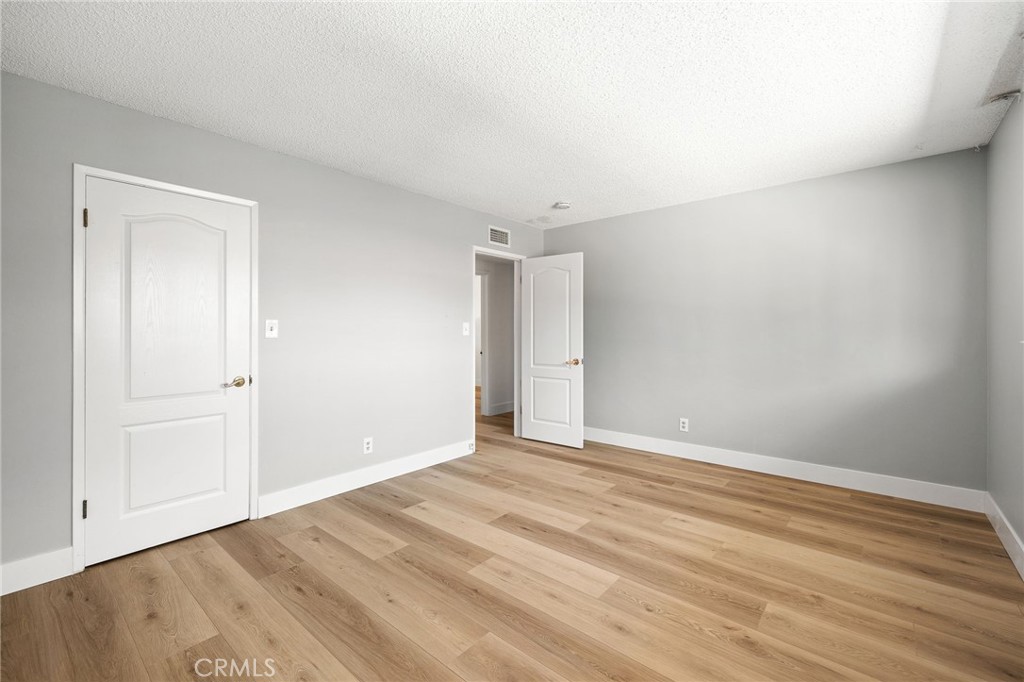 1176 Steele Drive Brea, CA 92821 - Photo 26 of 39 a view of an empty room with wooden floor