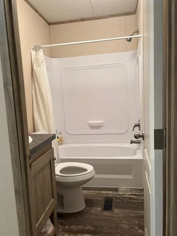 a bathroom with a toilet and a shower