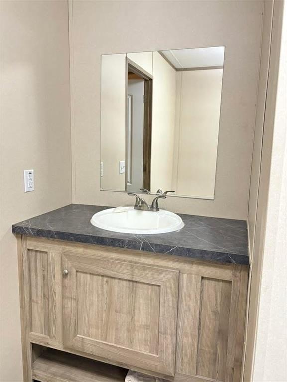 100 Shanee Drive Gloster, LA 71030 - Photo 14 of 19 a bathroom with a granite countertop sink and a mirror