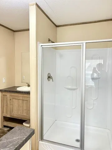 a bathroom with a shower and a sink