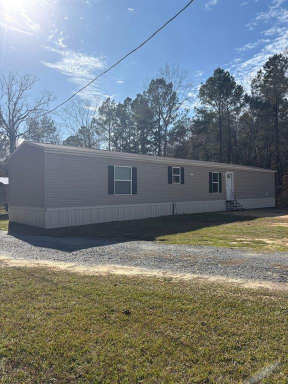 100 Shanee Drive Gloster, LA 71030 - Photo 2 of 19 a view of a swimming pool with a yard