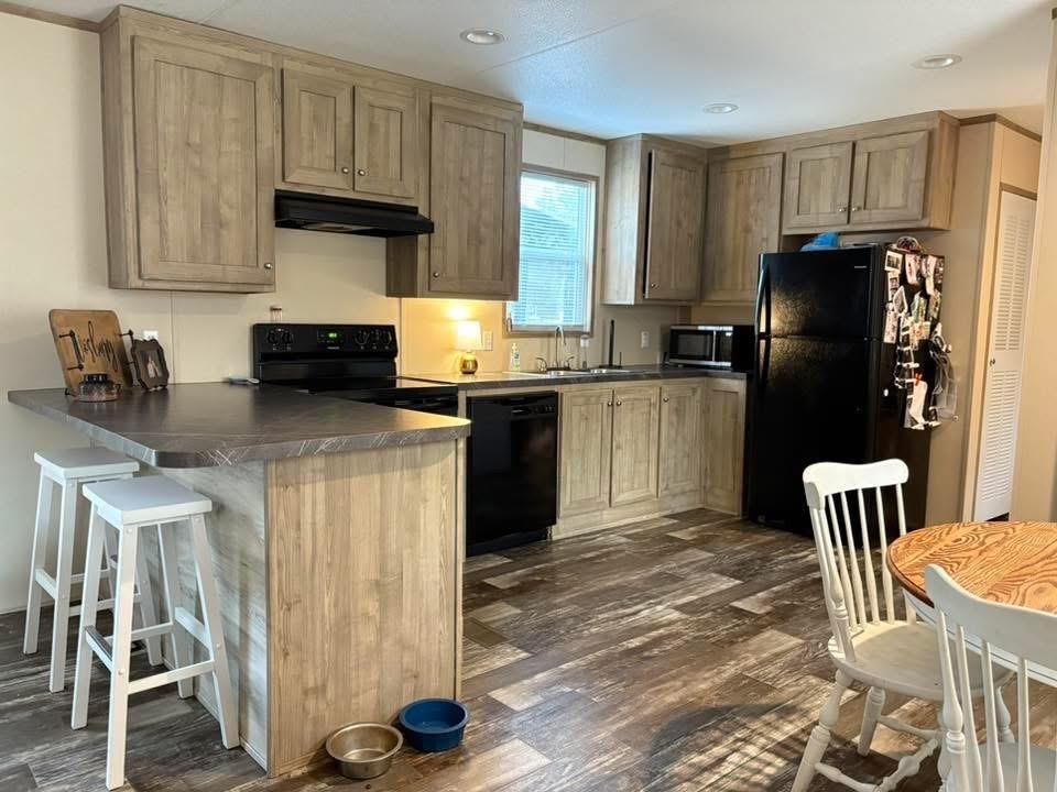100 Shanee Drive Gloster, LA 71030 - Photo 4 of 19 a kitchen with granite countertop a refrigerator stove top oven and sink