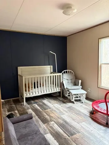 a bedroom with furniture and a window