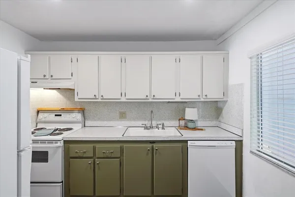 a bedroom with a bed and a window with outer view