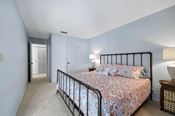 a bedroom with a large bed and a large window