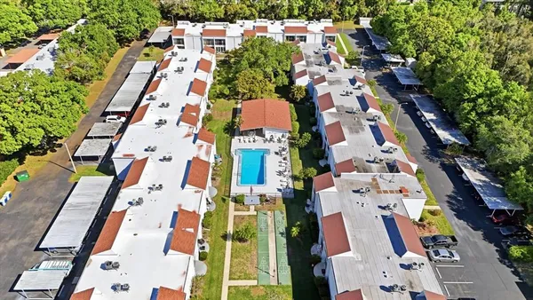 an aerial view of residential houses with outdoor space