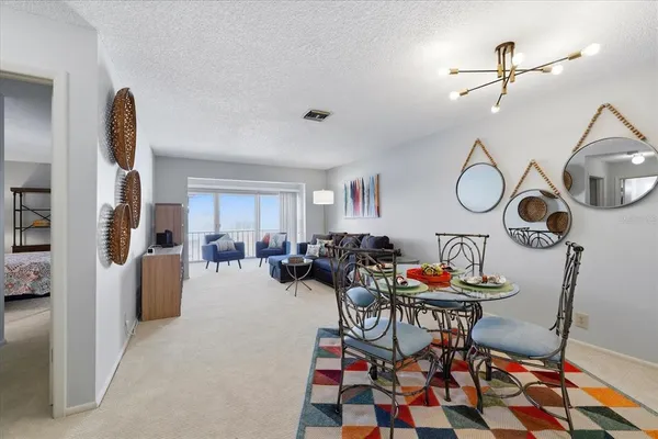 a view of a dining room with furniture and chandelier