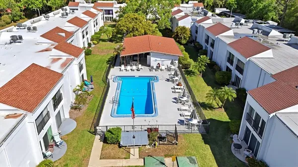 an aerial view of a house with a yard pool patio and outdoor seating