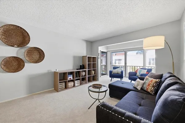 a living room with furniture and a book shelf