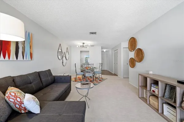 a living room with furniture wooden floor and a large window