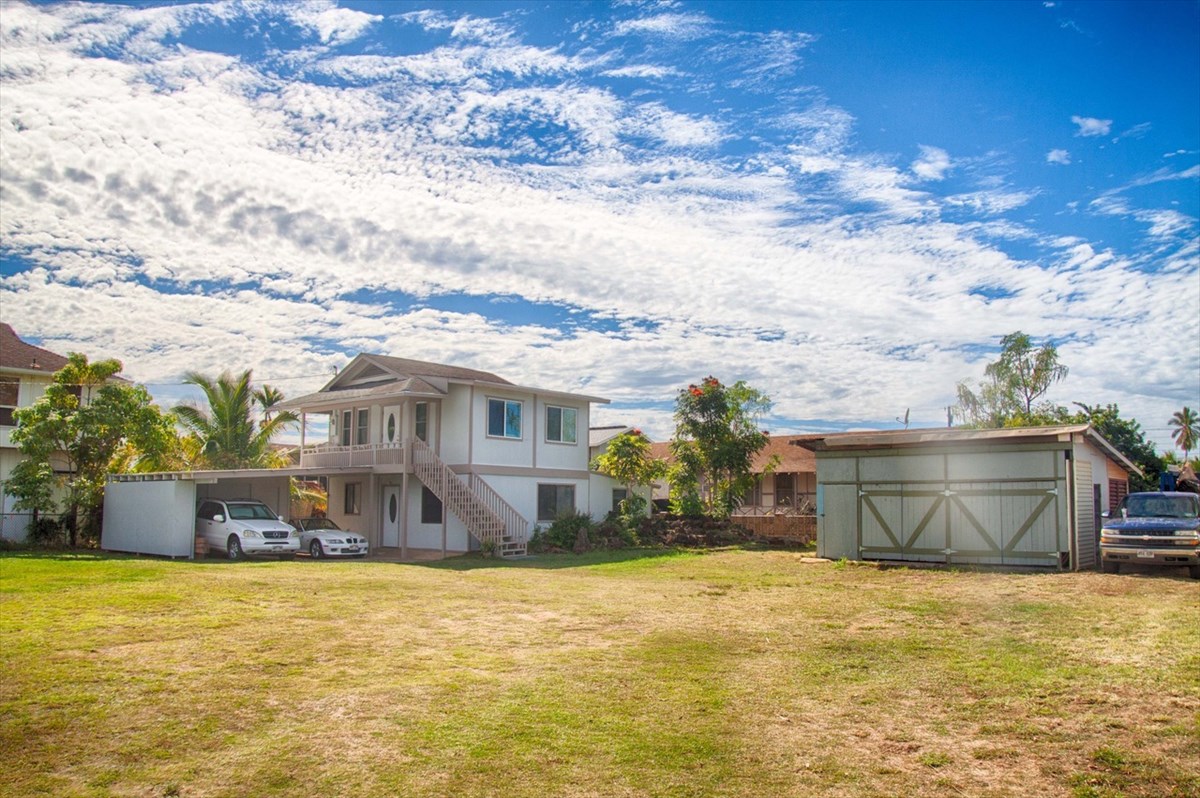 8560 Kekaha Road Kekaha, HI 96752 - Photo 1 of 5 a front view of a house with a yard and lake view