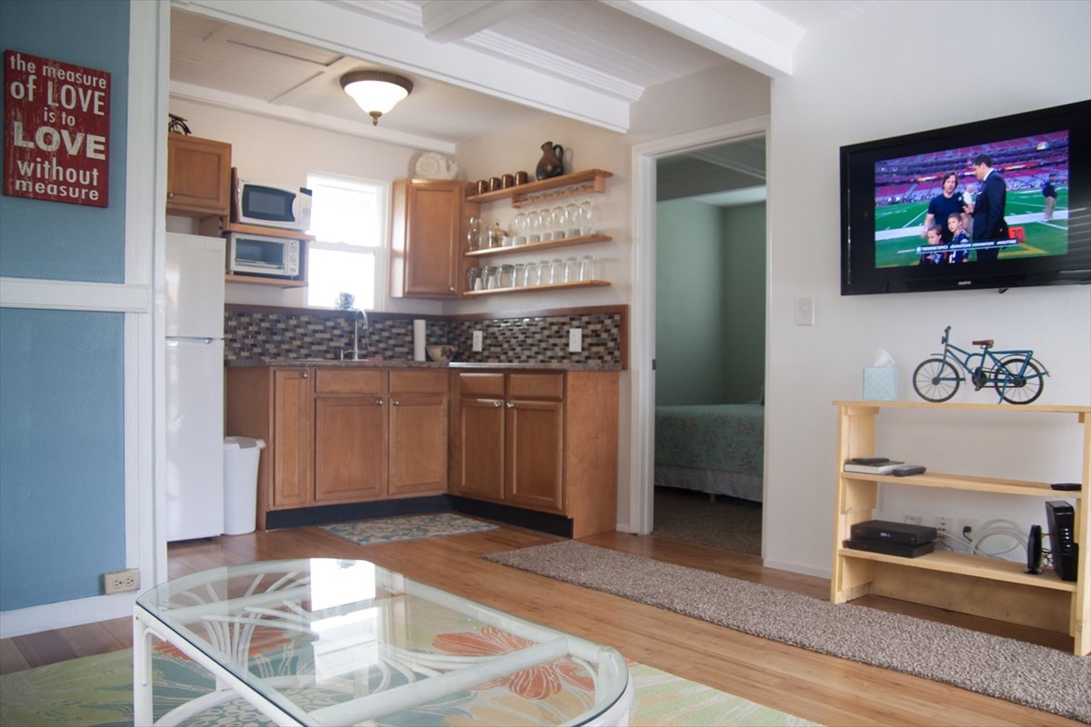 8560 Kekaha Road Kekaha, HI 96752 - Photo 3 of 5 a kitchen with granite countertop a stove and cabinets