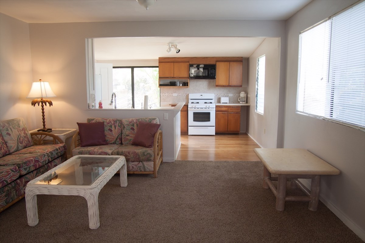 8560 Kekaha Road Kekaha, HI 96752 - Photo 4 of 5 a living room with stainless steel appliances furniture and a kitchen