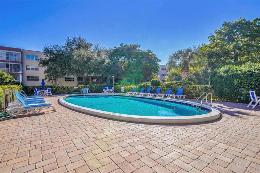 6731 Cypress Road, Unit 309 Plantation, FL 33317 - Photo 24 of 24 a view of a swimming pool with a yard