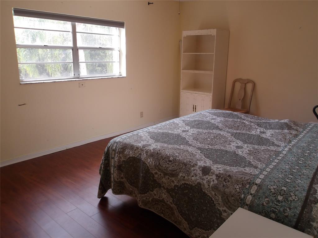6731 Cypress Road, Unit 309 Plantation, FL 33317 - Photo 7 of 24 a bed sitting in a bedroom next to a window