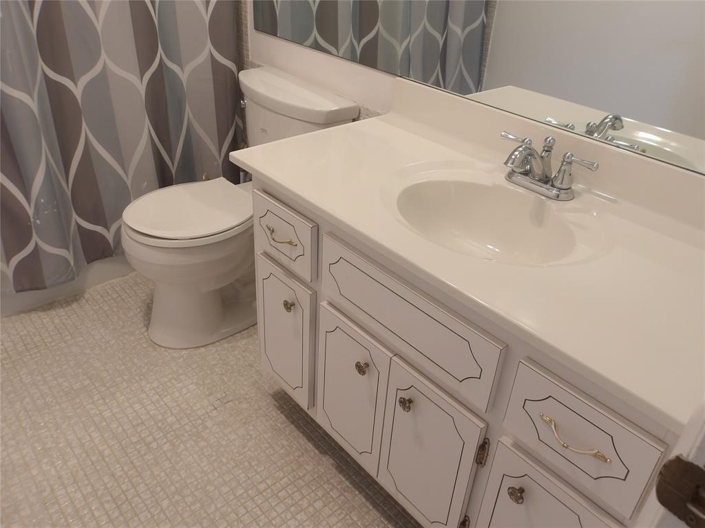 6731 Cypress Road, Unit 309 Plantation, FL 33317 - Photo 10 of 24 a white toilet sitting next to a bathroom sink