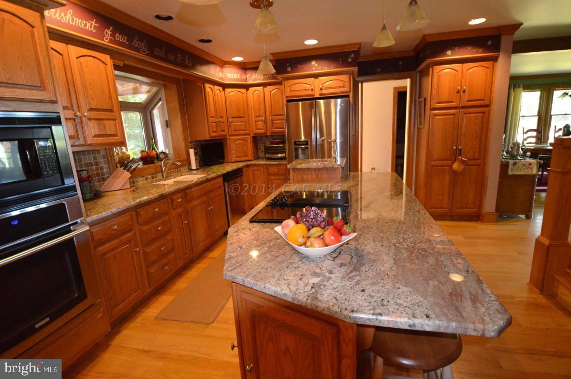 309 Silva Road Stockton, MD 21864 - Photo 17 of 67 a large kitchen with stainless steel appliances granite countertop a sink and counter space