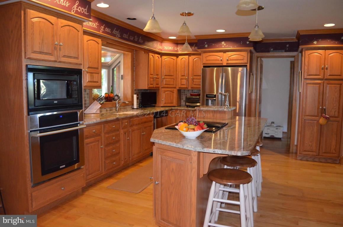 309 Silva Road Stockton, MD 21864 - Photo 20 of 67 a kitchen that has a microwave a stove and a refrigerator