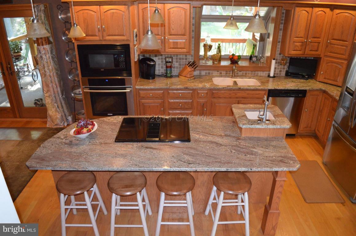 309 Silva Road Stockton, MD 21864 - Photo 22 of 67 a kitchen with a sink a counter top space and stainless steel appliances