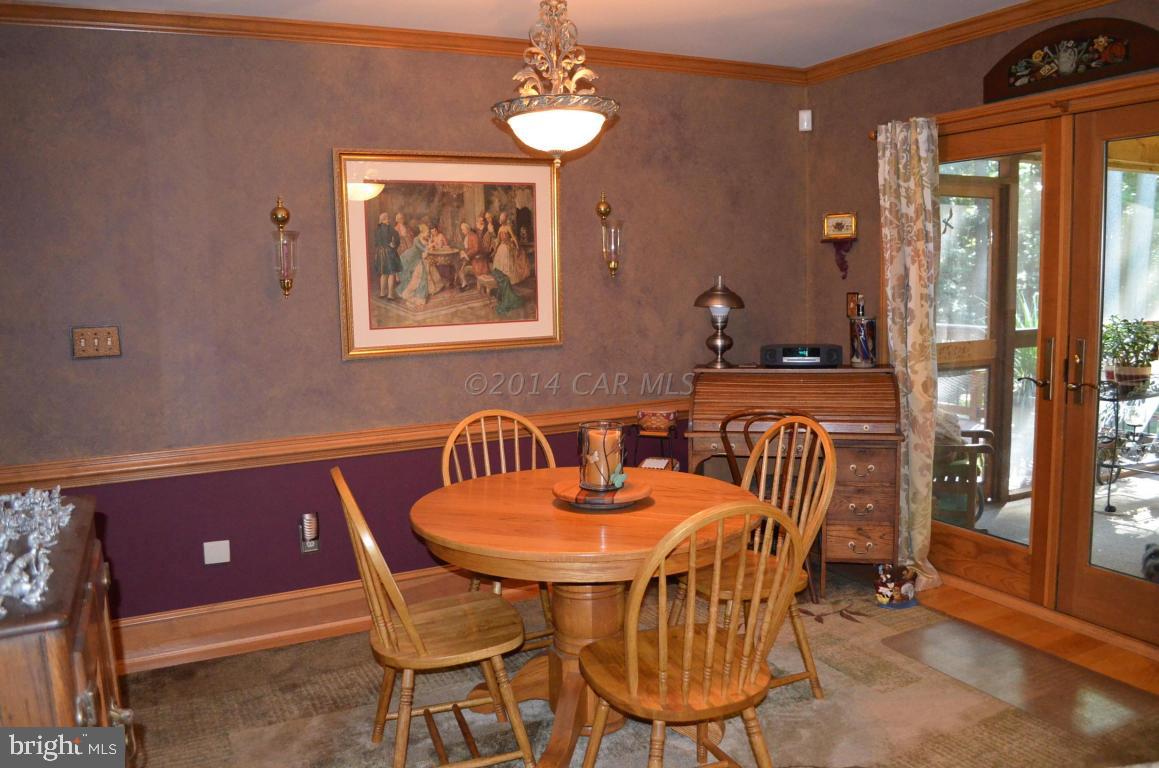 309 Silva Road Stockton, MD 21864 - Photo 26 of 67 a view of a dining room with furniture wooden floor and a chandelier
