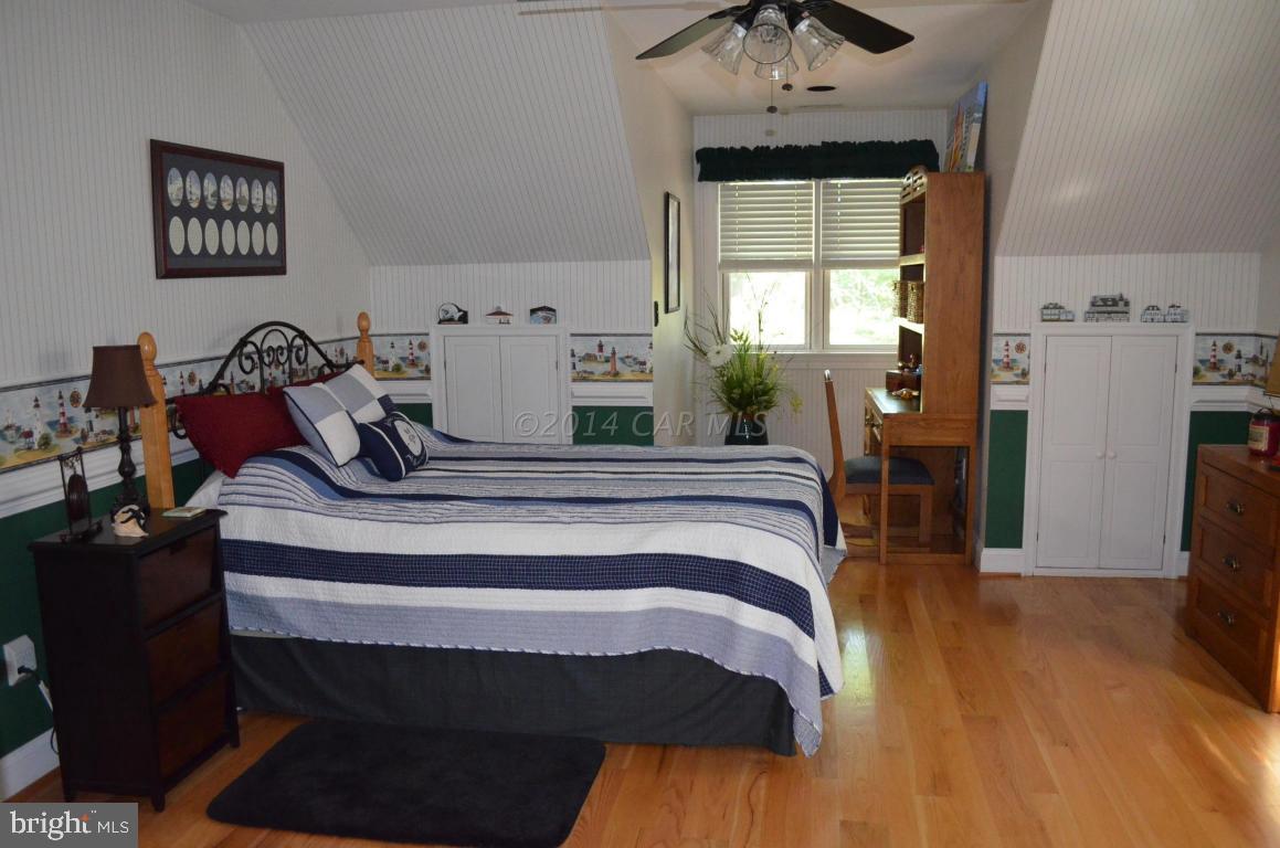 309 Silva Road Stockton, MD 21864 - Photo 40 of 67 a bedroom with a bed and wooden floor