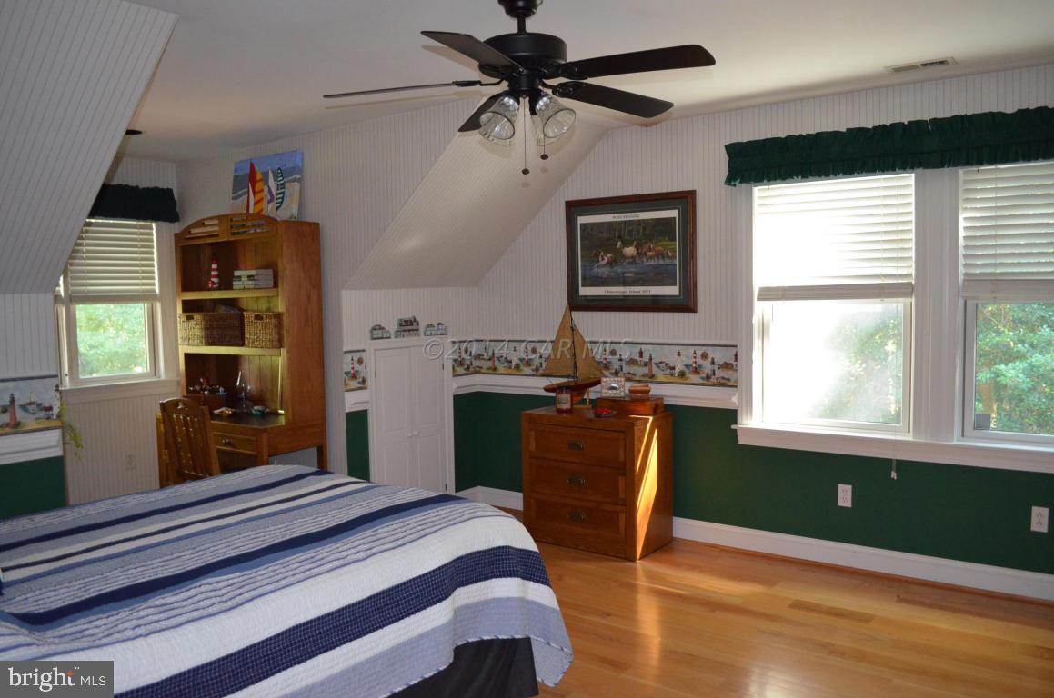 309 Silva Road Stockton, MD 21864 - Photo 42 of 67 a bedroom with a bed and a chandelier