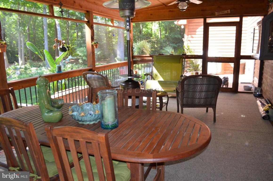 309 Silva Road Stockton, MD 21864 - Photo 48 of 67 a dining room with furniture a rug and a large window
