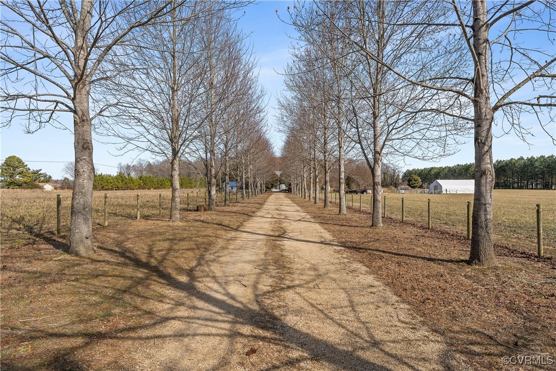 View of road featuring a rural view and driveway.