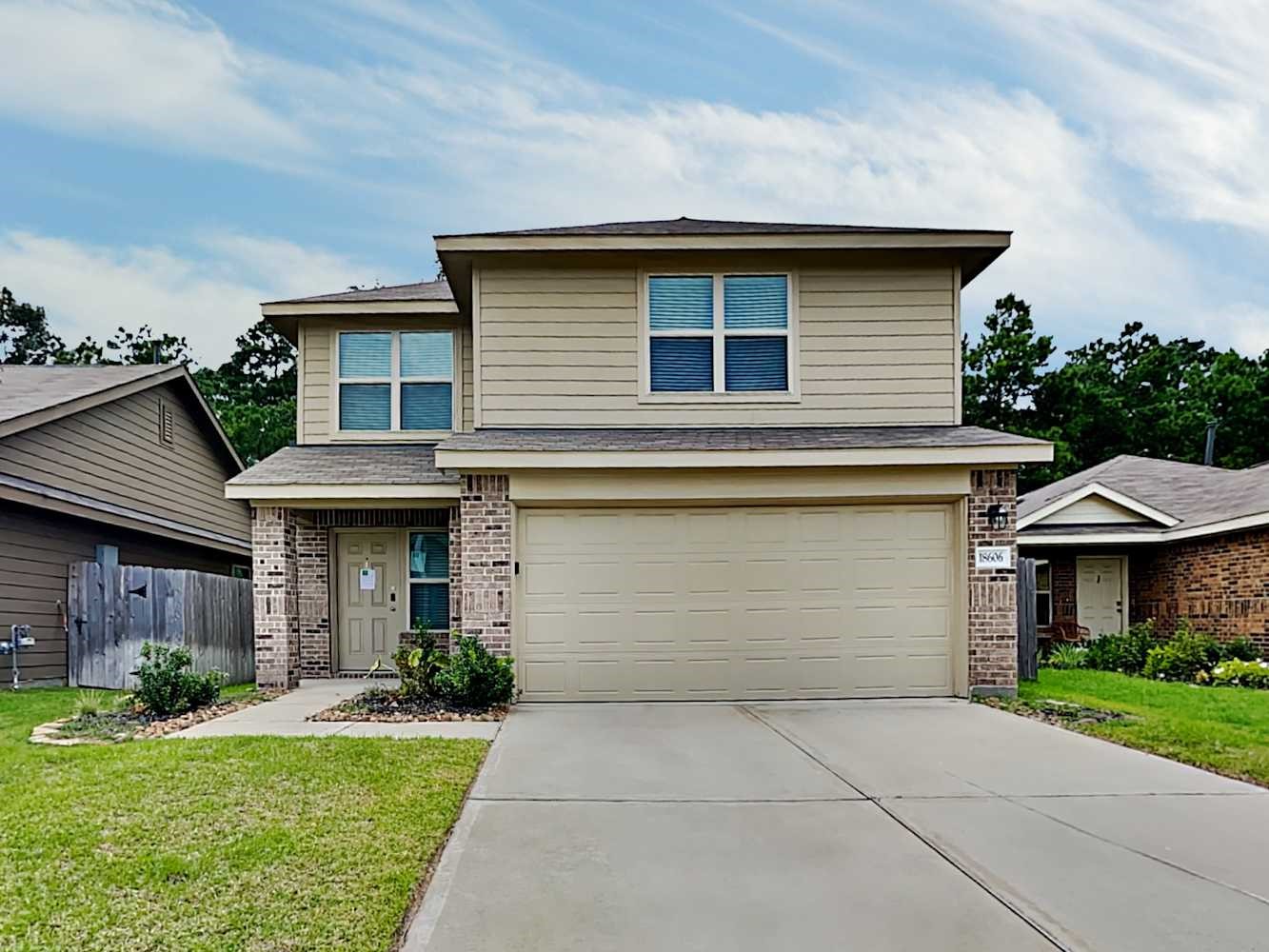 a front view of a house with a yard and garage