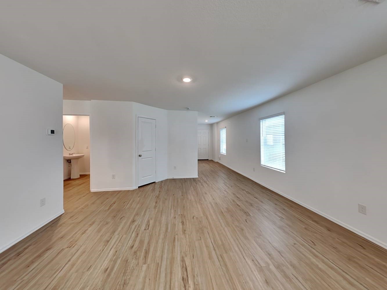 18606 Via Barletta Lane New Caney, TX 77357 - Photo 3 of 16 a view of an empty room with wooden floor and a window