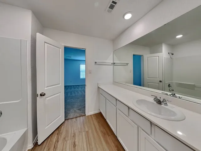 a bathroom with a sink a mirror and a shower