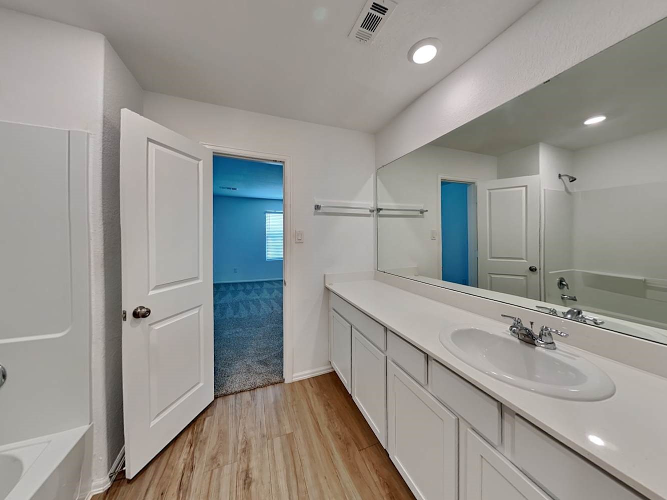 18606 Via Barletta Lane New Caney, TX 77357 - Photo 8 of 16 a bathroom with a sink a mirror and a shower